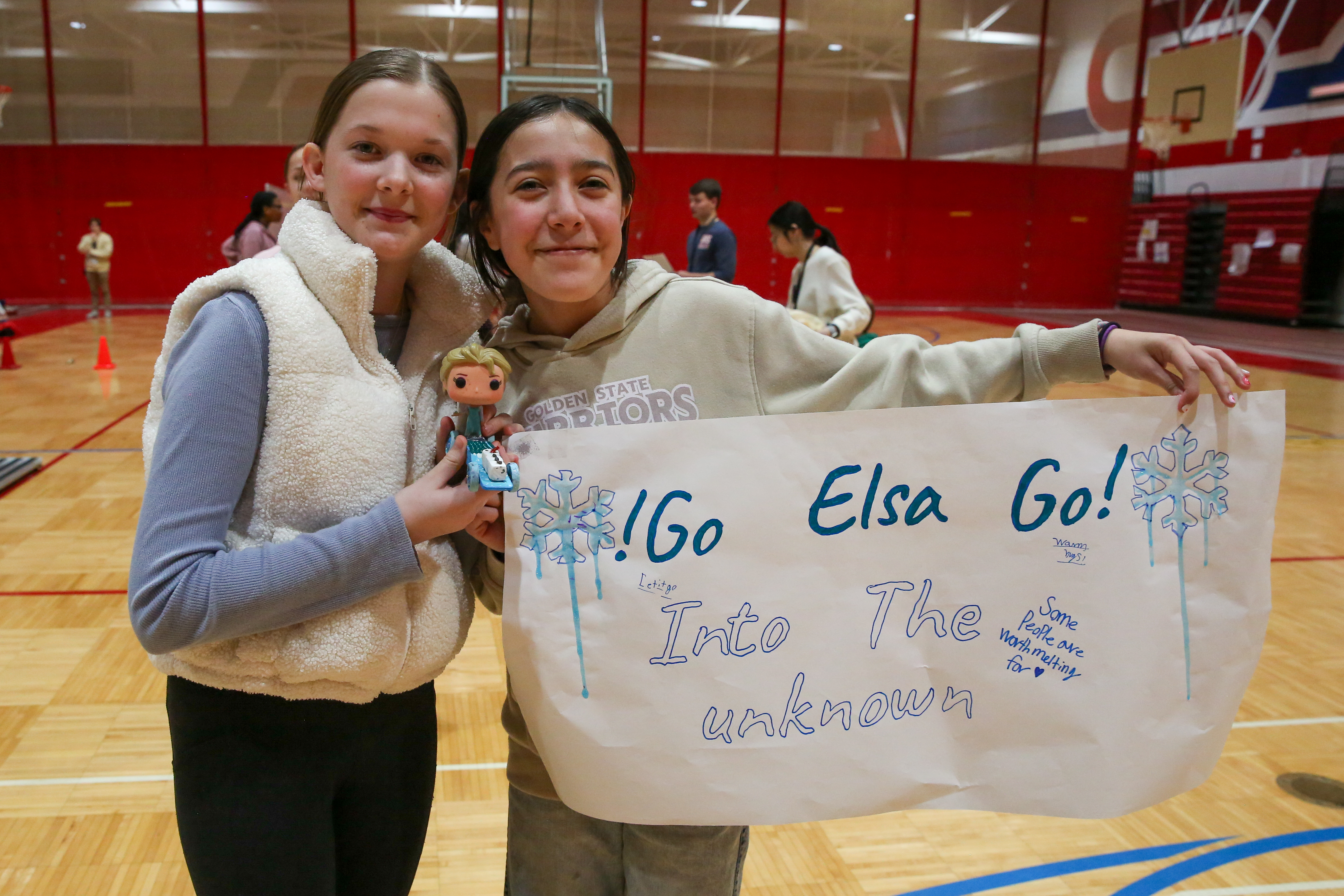 students hold their pinewood derby car