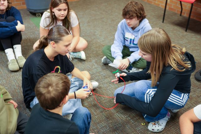 Children in a classroom setting, engaged in various activities.