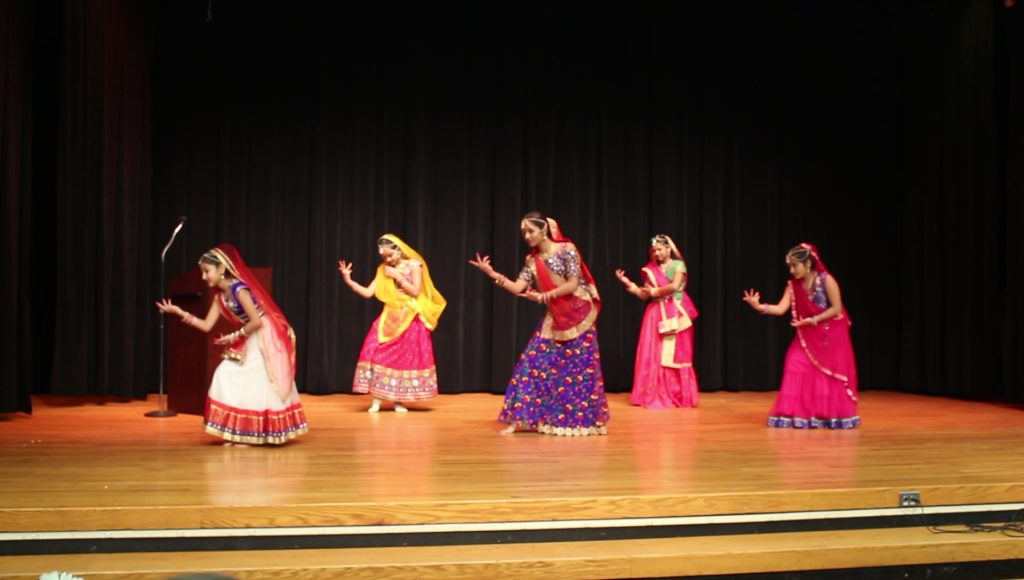 Group of dancers performing on stage.